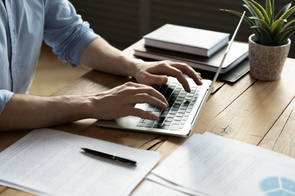 A person typing on a laptop computer.